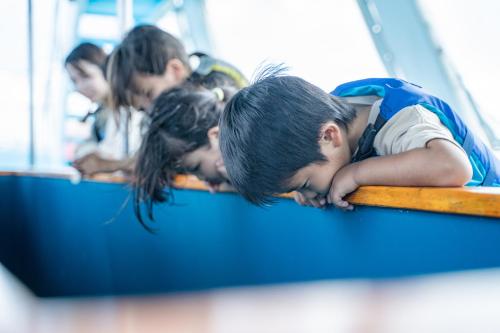 a group of children sleeping on a bus at Hotel Monterey Okinawa Spa & Resort in Onna