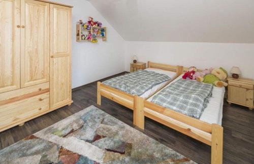 a bedroom with two beds with stuffed animals on them at Chalupa Biela 21 in Zázrivá