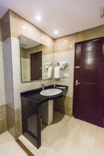 a bathroom with a sink and a mirror at Hotel Kausi in Pokhara