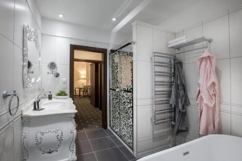 a bathroom with a tub and a sink and a shower at Château Šanov in Šanov