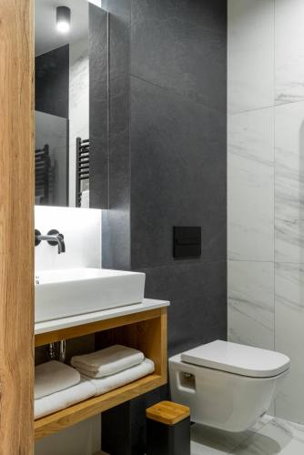 a bathroom with a white sink and a toilet at LILIOWA 15 in Dębki