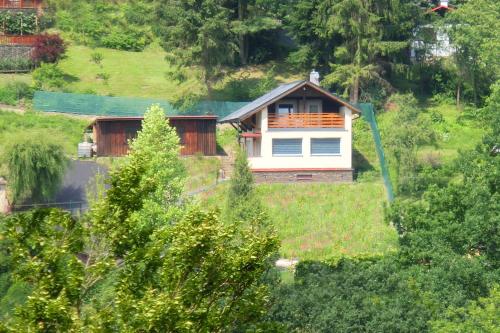 a house on top of a hill with trees at Chata Malá Skála v Českém ráji in Malá Skála