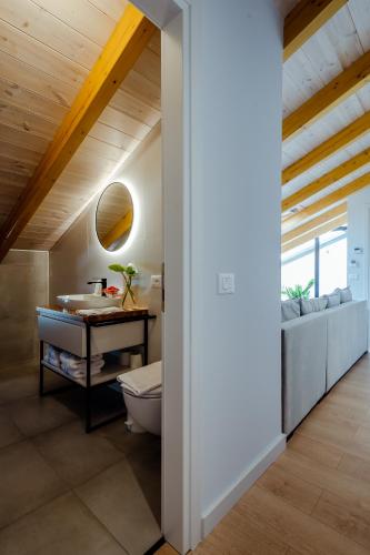 a bathroom with a toilet and a sink at Rea Boutique Hotel in Himare