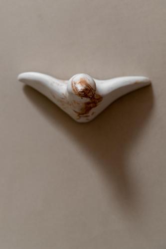 a close up of a white spoon with a bite out at Kaminos Boutique Hotel in Symi