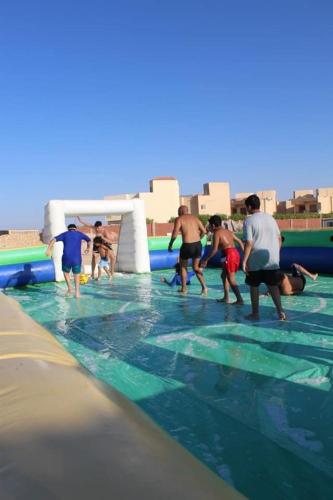 a group of people playing in a swimming pool at Mohamed Afifi Stella Heights - Sidi Abdel Rahman - Families - 3 Bed rooms in El Alamein