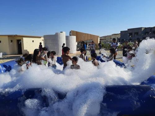a group of children playing in a foam bathtub at Mohamed Afifi Stella Heights - Sidi Abdel Rahman - Families - 3 Bed rooms in El Alamein