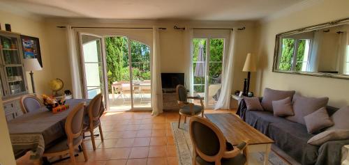 a living room with a couch and a table at Le Petit Mas de Grimaud in Grimaud