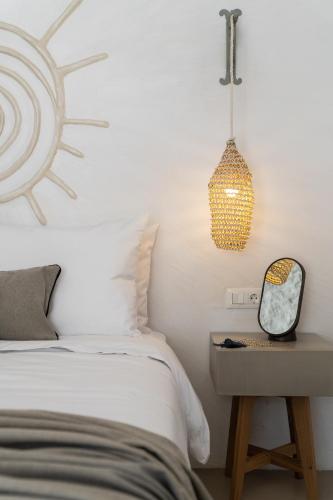 a bedroom with a bed and a table with a mirror at Kaminos Boutique Hotel in Symi