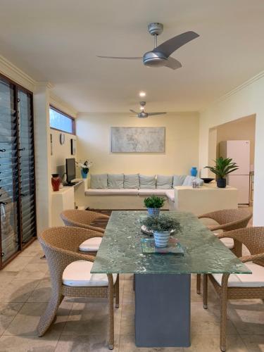 a living room with a table and chairs and a couch at Beachside 4 with private heated plunge pool in Port Douglas