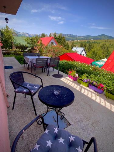 a patio with chairs and a table with stars on them at Apartment Ruzica in Žabljak