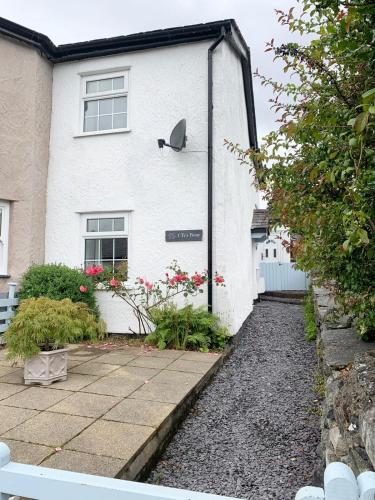 a white house with a walkway in front of it at Snowdonia Retreat in Trefriw