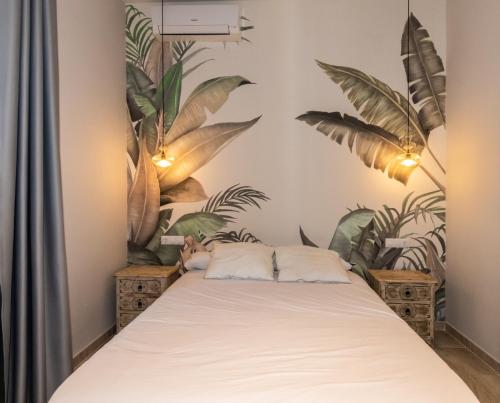 a bedroom with a bed with plants on the wall at Triana Pelay in Seville