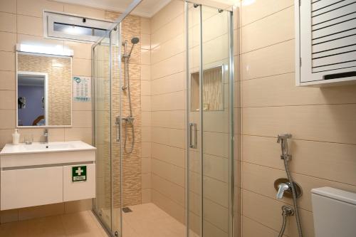 a bathroom with a glass shower and a sink at Vila do Largo by Madeira Sun Travel in São Vicente