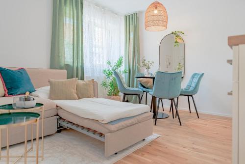 sala de estar con sofá, mesa y sillas en Garden.Lodge Spitz in der Wachau en Spitz
