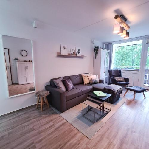 a living room with a couch and a table at Harz im Herzen in Altenau