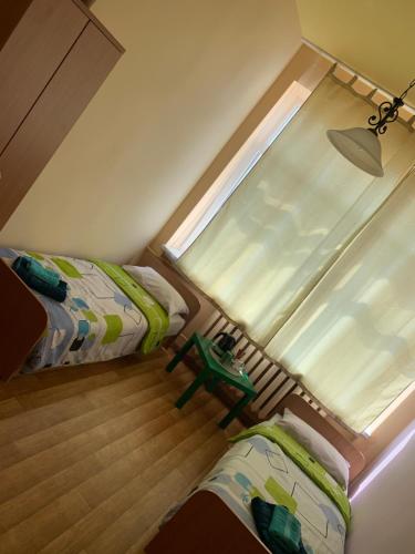 a small room with two beds and a window at Nuomojami kambariai Kelmeje in Kelmė