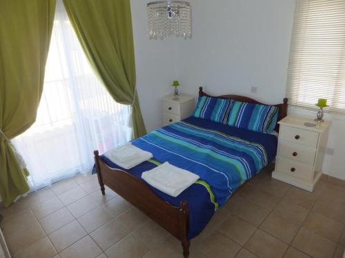 a bedroom with a bed with two towels on it at Cyking Apartment 103 postcode 8046 in Paphos