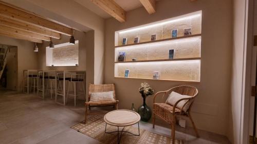 a room with chairs and a table and a counter at Marosi Boutique Hotel in Ciutadella