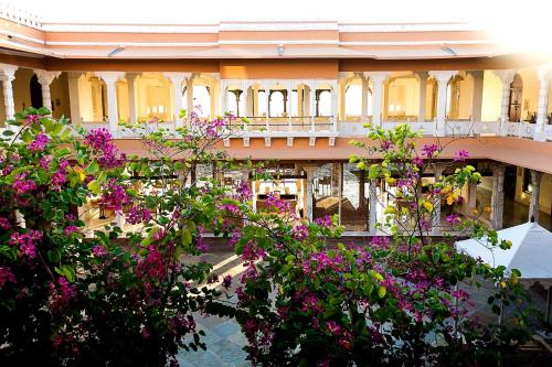 a building with flowers in front of it at Fateh Garh Resort by Fateh Collection in Udaipur