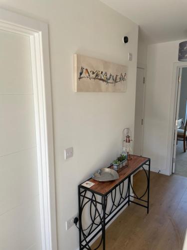 a table in a room with a picture on the wall at Woodside retreat holiday home in Aviemore in Aviemore