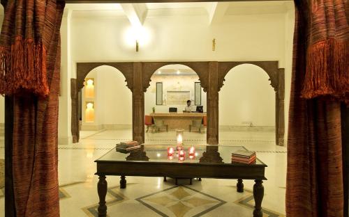 a room with a table with a candle on it at Fateh Garh Resort by Fateh Collection in Udaipur