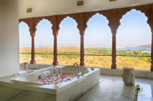 a bathroom with a tub filled with sprinkles at Fateh Garh Resort by Fateh Collection in Udaipur