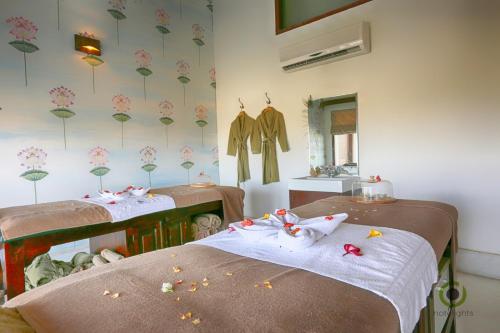 two beds in a room with dolls on them at Fateh Garh Resort by Fateh Collection in Udaipur