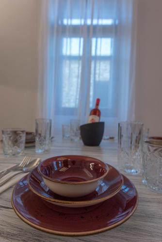 a table with a plate and a bowl on a table at 1571_SUITES A1 in Nafpaktos