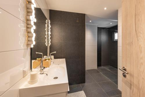 a bathroom with a sink and a shower at Hôtel - Restaurant " Victor Hugo" in Vianden