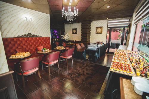 a restaurant with tables and chairs and a chandelier at aSa Boutique Hotel in Haskovo