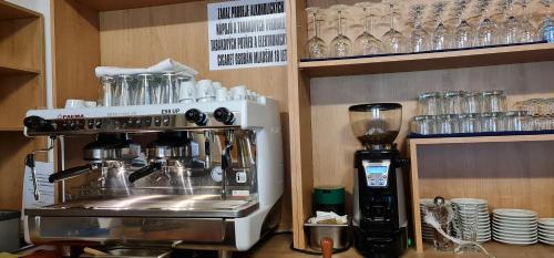 a kitchen with a coffee maker and a blender at Hotel Berounka in Hřebečníky