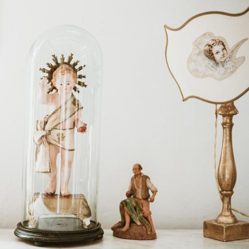a man in a glass dome next to a figurine at Boutique Hotel I Cinque Balconi in Santa Marina Salina