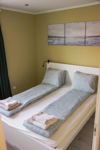 two beds in a room with towels on them at Pine&Chill2 Apartments in Balatonalmádi