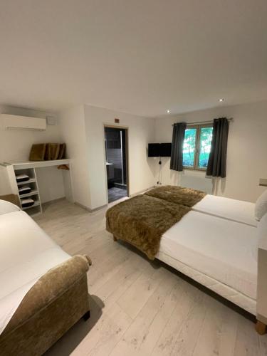 Le Lodge du Pichat tesisinde bir odada yatak veya yataklar