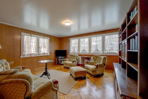 a living room with couches chairs and a television at Blattenheimat - im traditionellen Appenzeller Haus in Appenzell
