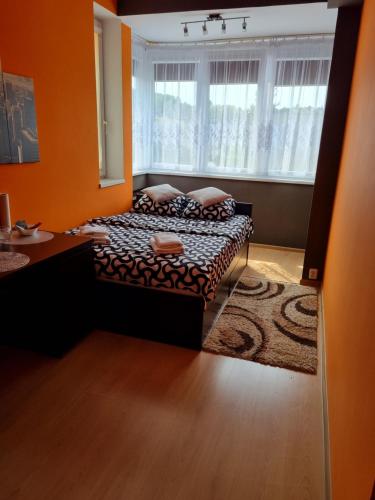 a bedroom with a bed and a large window at Pokoje Gdynia Orłowo in Gdynia