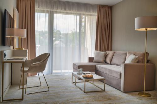 a living room with a couch and a table at Five Seasons Szklarska Poręba in Szklarska Poręba
