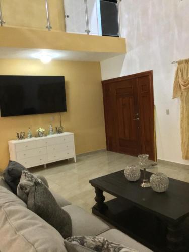 a living room with a couch and a table at Villa Nilsa ( The Blue House ) in Baní