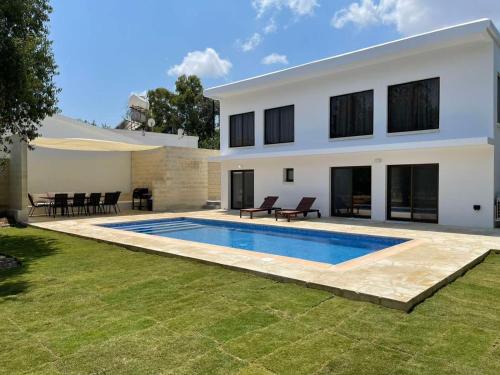 a house with a swimming pool in the yard at Villa Athasia in Yiolou