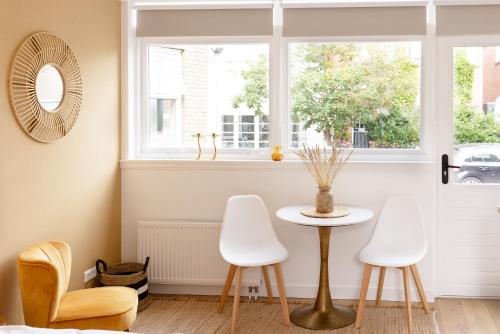 a room with a table and two chairs and a window at Paradise Beach Studio in Zandvoort
