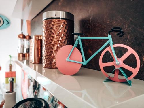 a pink and blue bike sitting on a shelf at Townhouse in Friedrichstadt