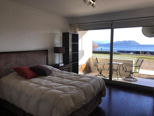 a bedroom with a bed and a view of the ocean at Quintaluna in San Carlos de Bariloche