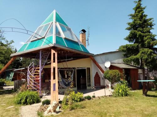a house with a glass roof on top of it at Penzion Slunce nad Vinným Sklepem in Moravská Nová Ves