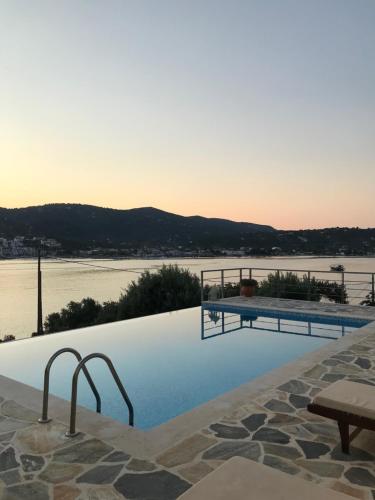 a swimming pool with a view of the water at Villa Lazareta in Punta