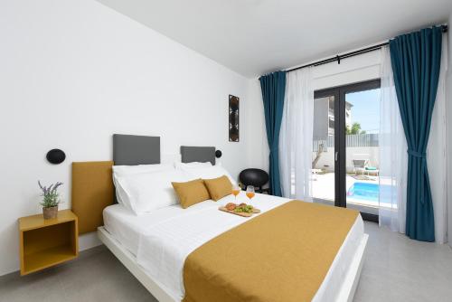 a bedroom with a large bed and a pool at Villa Pjaula in Zadar