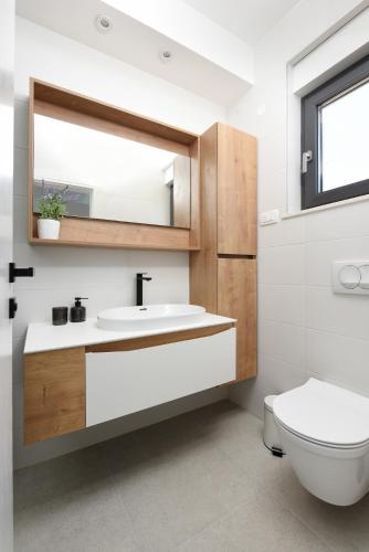 a bathroom with a sink and a toilet at Villa Pjaula in Zadar