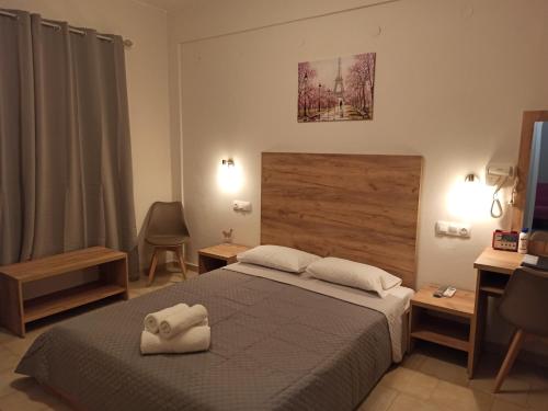 a bedroom with a bed with two towels on it at Summer Desire in Kavos