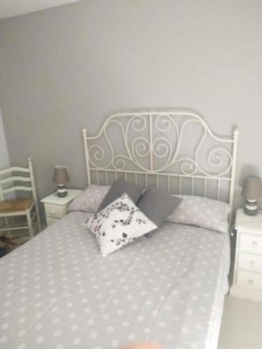 a bed with two pillows on it in a bedroom at VikerBIESCAS in Biescas