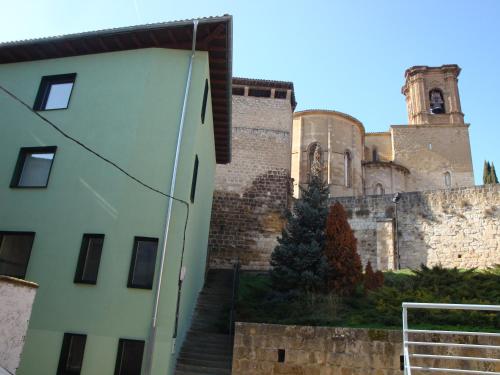 a large building with a clock on the side of it at Agora Hostel in Estella