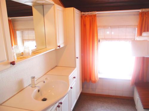 a bathroom with a sink and a mirror and a window at Hotel Am Römerhof in Bonn